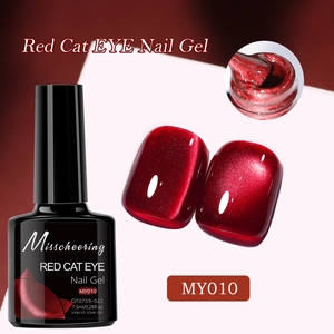 Detail of red cat eye nail gel bottle with swatches and brush applicator texture