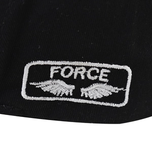 Detailed close-up of white FORCE letter embroidery with wings on black cotton baseball cap