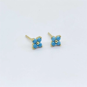 Macro shot of S925 sterling silver four-leaf clover stud earrings with turquoise gems