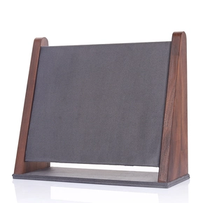 Macro detail of walnut wood necklace stand with grey velvet padding and sleek reflection