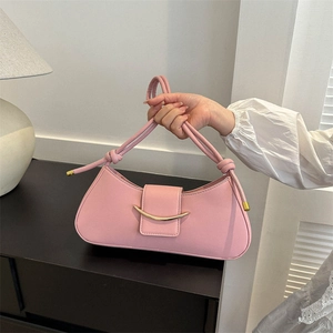 Pink crescent handbag with gold metal trim and knotted shoulder strap detail