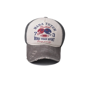 Close-up of vintage washed denim baseball cap featuring distressed brim and rugby embroidery
