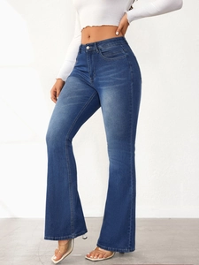 Detail shot of high-waisted flared jeans in dark blue wash with slim-fit tailoring