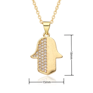Detail view of gold Hamsa Hand pendant measuring 18mm by 15mm with white zircons