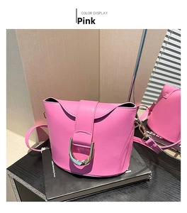 Detailed view of pink PU leather saddle bag with large gold D-ring buckle closure