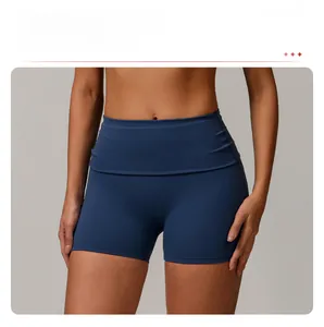 Close-up of high-waisted crossover fold-over waistband on navy blue yoga shorts