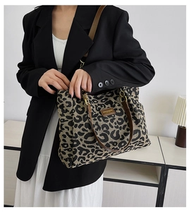 Leopard print tote bag shown on shoulder with black blazer for daily stylish commuting
