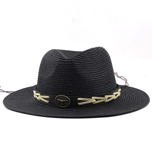 Close-up of black straw fedora featuring a faux leather band with a bull head metal emblem