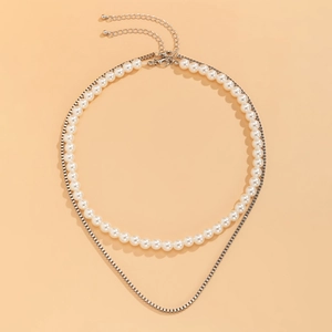 Detail of double-layer necklace with white pearls, silver box chain and lobster clasp