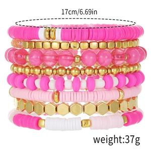 Detail of 8-piece bohemian layered polymer clay bracelets in pink and white tones