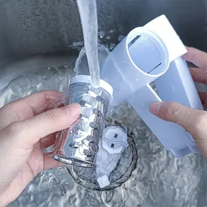 Rotary cheese grater with stainless steel drum being rinsed under water for easy cleaning