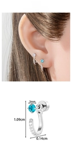 Macro detail of U-shaped steel earring with blue zircon and micro-inlaid rhinestones