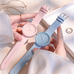 Close-up of macaron color watches with embossed numerals and matte leather straps