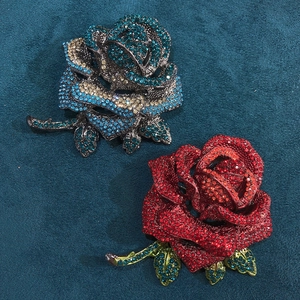 Exquisite rose brooches with colorful rhinestones in vibrant red and gradient blue tones