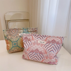 Chinese style makeup bags with floral and wave patterns, featuring metal zipper closures
