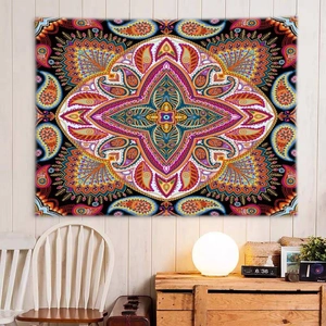 Detailed view of bohemian mandala tapestry featuring vibrant paisley patterns on a wall