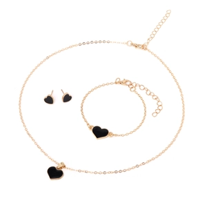 Golden jewelry set with black heart pendants including necklace, bracelet and earrings