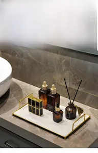 Detail of luxury marble pattern bathroom tray with gold metal frame and side handles