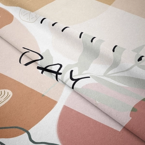 Close-up of soft flannel tapestry featuring abstract botanical leaves and DAY lettering