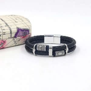 Detail of double-layer black braided leather bracelet with Nordic Viking metal beads