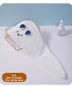 Detail of soft white coral fleece hair towel wrap with cute embroidered bear ears