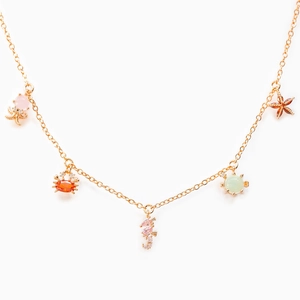 Detail of gold necklace with colorful zircon octopus, seahorse and turtle pendants