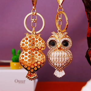 Detailed view of rhinestone owl keychain showing front crystals and golden cutout back pattern