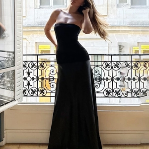 Detailed view of elegant black strapless evening dress with slim fit and satin finish texture