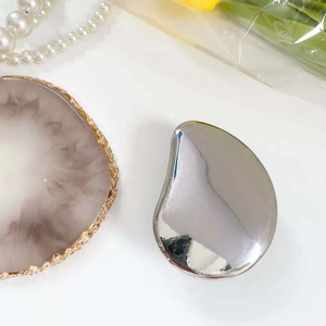 Macro shot of silver plated mirror phone socket on a white luxury prop display