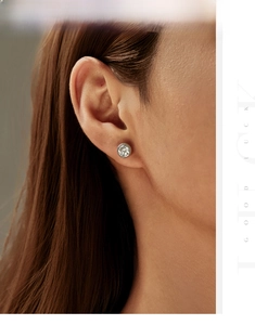 Close-up of 6.5mm round moissanite bubble earring in S925 silver on a model ear