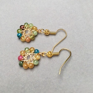 Tourmaline crystal beaded earrings with 14K gold wire wrap on a textured background