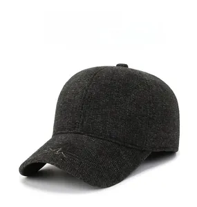 Close-up of wool-textured winter baseball cap featuring mountain embroidery and metal shield logo
