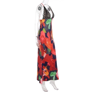 Detail of vibrant floral print dress featuring black lace trim and deep V-neckline