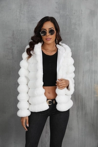 Detailed texture of white faux fur hooded jacket with plush quilted segments for winter
