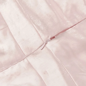 Close-up of pink satin fabric with high-quality matching invisible zipper detail