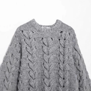 Women's gray chunky knit sweater featuring 3D heart cable texture and crew neckline