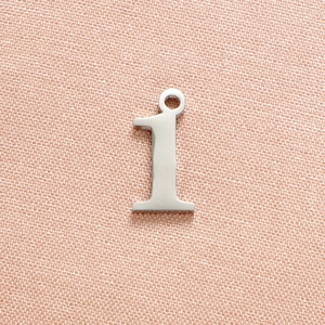 Top view of silver stainless steel number 1 pendant with textured metal surface