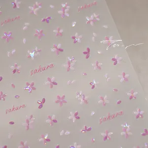 Macro shot of pink sakura flower nail art stickers with holographic laser finish