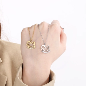 Detail of gold and silver rocking horse pendants with sparkling cubic zirconia inlay