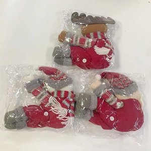 Close-up of plush Christmas curtain buckles featuring reindeer and elf characters