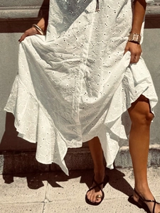 White eyelet embroidery dress with button-down front and ruffled hem in summer style