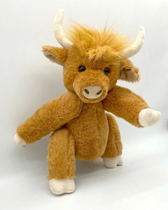 Close-up of the long fluffy brown fur and white curved horns on the Highland Cow plush