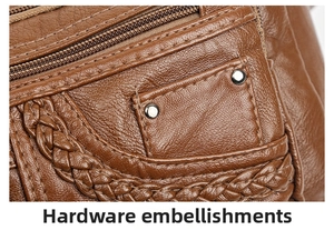 Detail of brown litchi leather bag with woven edges and decorative metal hardware rivets
