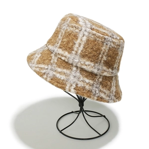 Close-up of brown and white plaid teddy fleece bucket hat with warm wool-like texture