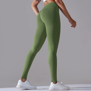 Detail view of olive green high waist seamless yoga pants with peach lift sculpting seams