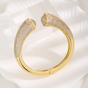 Elegant gold open bangle featuring micro-pave white zircons and geometric round ends