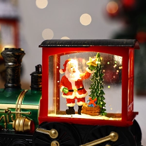 Close-up of Santa Claus inside a water-filled Christmas train ornament with warm light