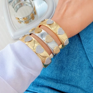 Adjustable gold and silver heart bracelets with micro-pave crystals on wrist