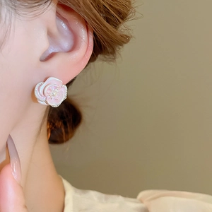 Detail of pink gradient enamel flower earring with tiny crystals and a white pearl inlay