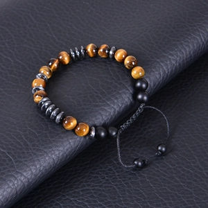 Detail of 8mm tiger eye beads and hematite discs on adjustable braided rope cord